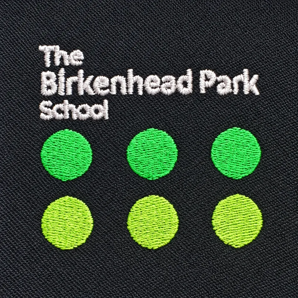 Birkenhead Park School name and six green circles embroidered on dark fabric